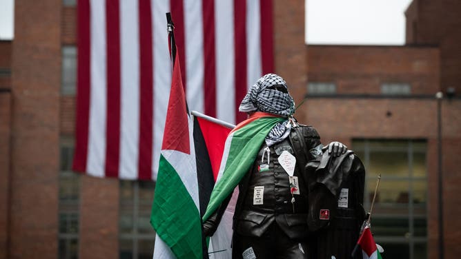 The statue of George Washington at the University that bears his name wears Palestinian flags, kefiyeh and stickers thanks to anti-Israel, pro-Hamas and anti-American demonstrators.