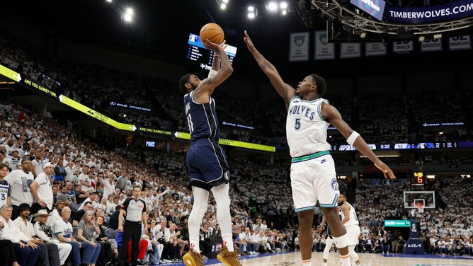Dallas Mavericks SG Kyrie Irving shoots a fadeaway over Timberwolves All-Star Anthony Edwards during Game 1 of the Western Conference Finals at Target Center in Minnesota. (David Berding/Getty Images)
