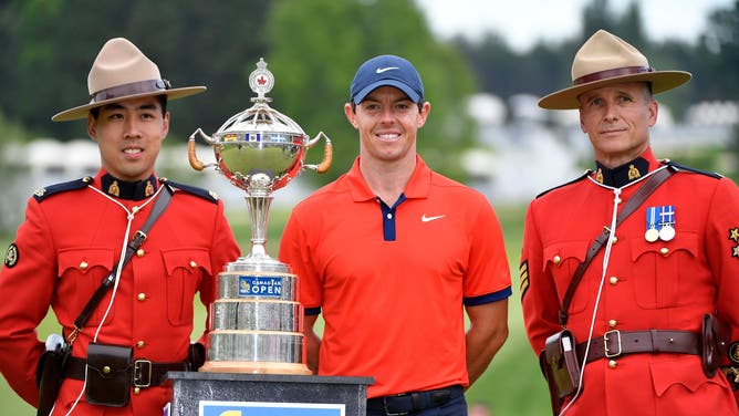 Rory McIlroy poses with the trophy and two members of the Royal Canadian Mounted Police after winning the 2019 RBC Canadian Open golf tournament at Hamilton Golf & Country Club. (Eric Bolte-USA TODAY Sports)