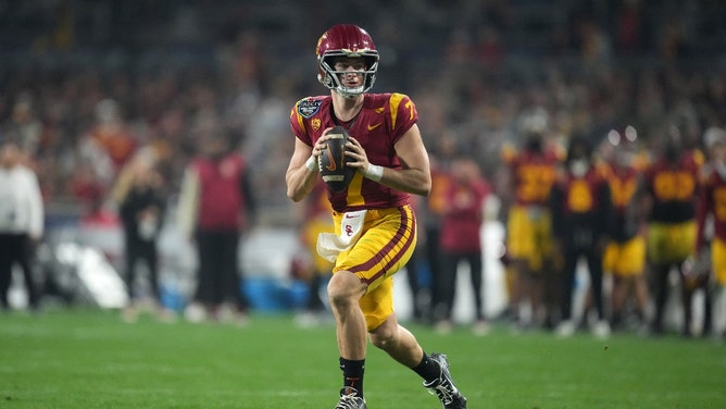 USC Trojans QB Miller Moss rolls out to throw against Louisville Cardinals in the Holiday Bowl at Petco Park in San Diego. (Kirby Lee-USA TODAY Sports)