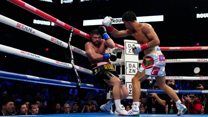 Jaime Munguia hits John Ryder causing him to stumble into the ropes during their bout at the Footprint Center in Phoenix, Arizona. (Patrick Breen/The Republic/USA TODAY NETWORK)