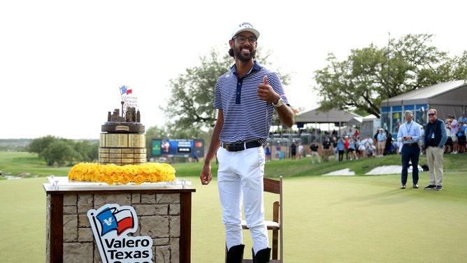 Akshay Bhatia poses with a pair of boots after winning a playoff in the final round of the 2024 Valero Texas Open in San Antonio. (Erik Williams-USA TODAY Sports)