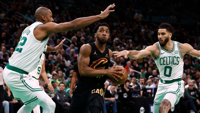 Cleveland Cavaliers SG Donovan Mitchell attacks Boston Celtics SF Jayson Tatum and C Al Horford off the dribble in the 2024 NBA Playoffs at TD Garden in Boston. (Winslow Townson-USA TODAY Sports)