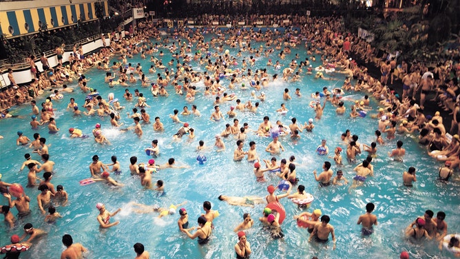 A packed swimming pool for a local town. 