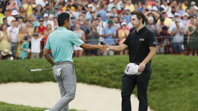 Collin Morikawa shakes hands with Patrick Cantlay on 18 following their playoff hole during the final round of the 2021 Memorial Tournament at Muirfield Village Golf Club in Dublin, Ohio. (Adam Cairns/Columbus Dispatch/USA TODAY NETWORK)