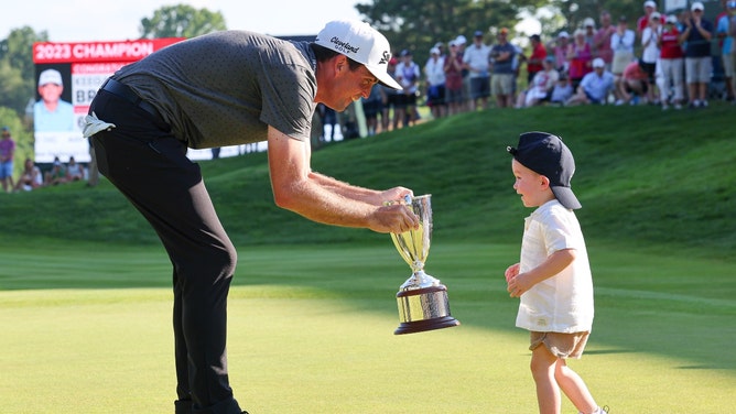 Keegan Bradley celebrates with his son after the 2023 Travelers. (Vincent Carchietta-USA TODAY Sports)
