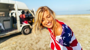 Nick Saban's daughter, Kristen, dominated the lake for the Fourth of July while country singer Sara Evans wrapped up in an American flag towel. 