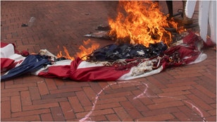 Hero saves American flag. (Credit: Getty Images)