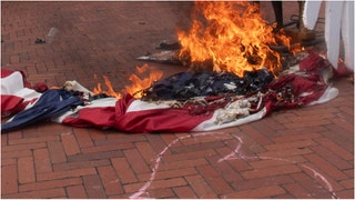 Hero saves American flag. (Credit: Getty Images)