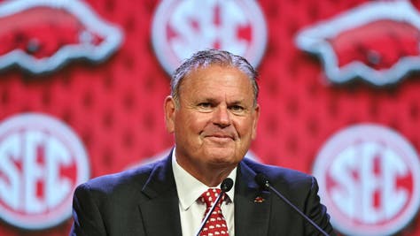 Sam Pittman waves to the media as he takes the stage to talk about his Arkansas Razorbacks football program at SEC Media Days