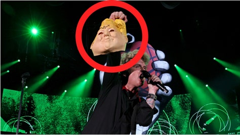 Green Day singer Billie Joe Armstrong was slammed for holding up a fake head of Donald Trump during a concert. Check out the reactions. (Credit: Getty Images)