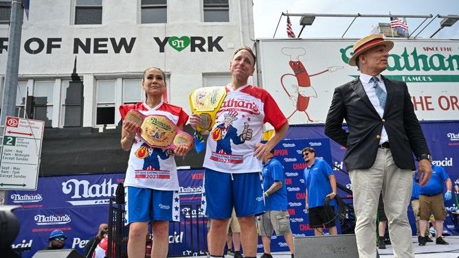 The women's winner, Miki Sudo, and men's champion, Joey Chestnut, after the 2023 Nathan's Dog Eating Contest on July 4, 2023 in Coney Island, Brooklyn. (Alexi J. Rosenfeld/Getty Images)