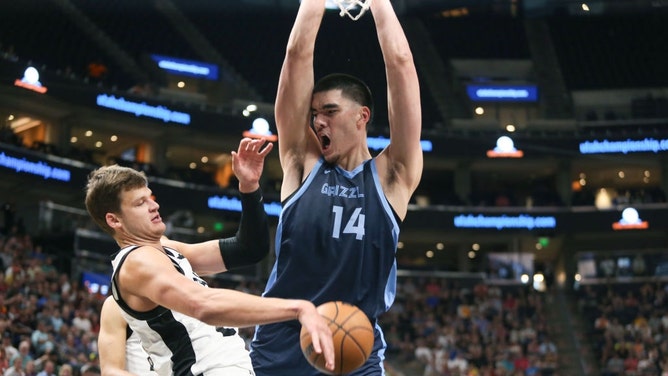 Memphis Grizzlies rookie C Zach Edey dunks on Utah Jazz C Walker Kessler in a 2024 NBA Salt Lake Summer League game. (Chris Gardner/Getty Images)