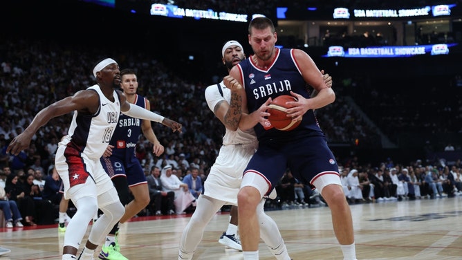 Serbia C Nikola Jokic drives to the basket on American C Anthony Davis and PG Bam Adebayo during a preparation game for the Paris Olympic Games at Etihad Arena in Abu Dhabi, United Arab Emirates. (Christopher Pike/Getty Images)
