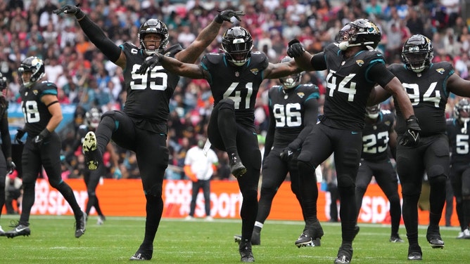 Jacksonville Jaguars DT Roy Robertson-Harris and pass rushers Josh Hines-Allen and Travon Walker celebrate vs. the Atlanta Falcons at Wembley Stadium in London. (Kirby Lee-USA TODAY Sports)