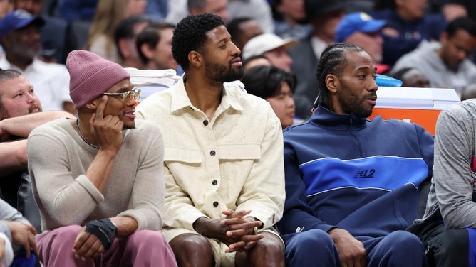 Former Los Angeles Clippers' Russell Westbrook and Paul George and current Clipper, Kawhi Leonard, watch the game from the bench Milwaukee Bucks at Crypto.com Arena. (Kiyoshi Mio-USA TODAY Sports)