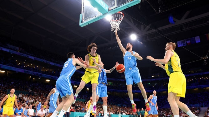 Australia SF Josh Giddey passes the ball to C Jock Landale in a game vs. Greece during the Paris Summer Olympics at Stade Pierre Mauroy in France. (Gregory Shamus/Getty Images)
