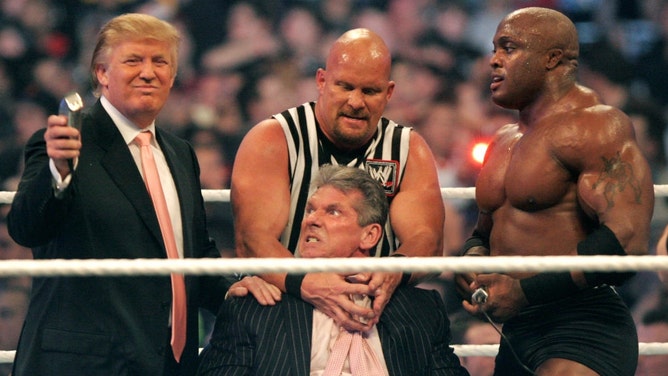 Former WWE chairman Vince McMahon gets held by Stone Cold Steve Austin while former President Donald Trump prepares to shave his head after losing the 'Battle of the Billionaires' Wrestlemania 23 at Ford Field in Detroit, Michigan. (Bill Pugliano/Getty Images)