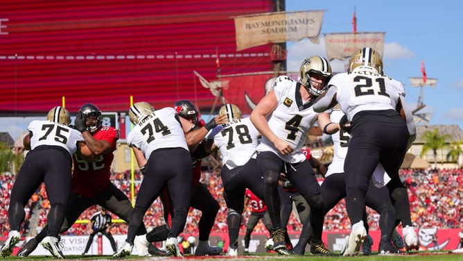 New Orleans Saints QB Derek Carr hands the ball against the Tampa Bay Buccaneers at Raymond James Stadium in Florida. (Nathan Ray Seebeck-USA TODAY Sports)