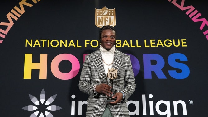 Baltimore Ravens QB Lamar Jackson poses with the 2023 NFL MVP trophy. (Kirby Lee-USA TODAY Sports)