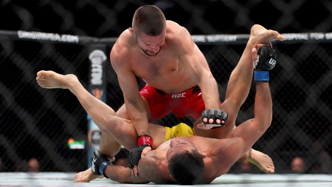 Mateusz Gamrot grounds and pounds Rafael Dos Anjos during UFC 299 at Kayesa Center in Miami. (Sam Navarro-USA TODAY Sports)