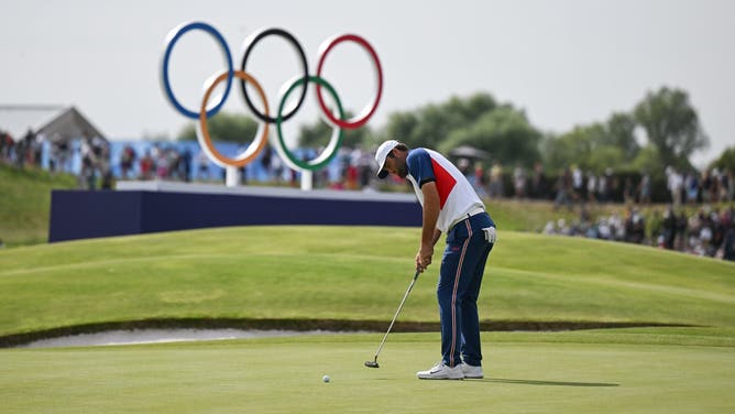 Scottie Scheffler of Team USA putts on the 18th green during the men's individual stroke play final round at Le Golf National during the 2024 Paris Summer Olympic Games in Paris, France.