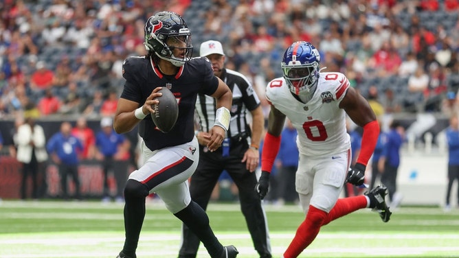 New York Giants pass rusher Brian Burns chasing Houston Texans QB C.J. Stroud during an NFL preseason game at NRG Stadium in Texas. (Tim Warner/Getty Images)
