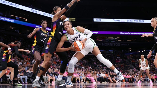 The Minnesota Lynx and Phoenix Mercury battle in the paint during Game 1 of their first-round 2024 WNBA playoff series at Footprint Center. (Chris Coduto/Getty Images)