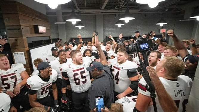 Northern Illinois players and coaches celebrate in the locker room following the win over Notre Dame. Courtesy of NIU Athletics