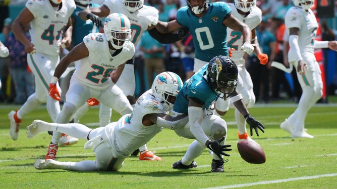 Miami Dolphins S Jevon Holland strips the ball from Jacksonville Jaguars RB Travis Etienne Jr. at Hard Rock Stadium in Florida. (Jim Rassol-Imagn Images)