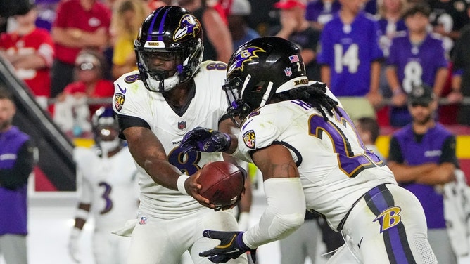 Baltimore Ravens QB Lamar Jackson hands off to RB Derrick Henry (22) against the Kansas City Chiefs in the 2024 NFL Kickoff Game at GEHA Field at Arrowhead Stadium. (Denny Medley-Imagn Images)