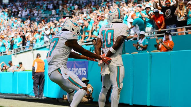 Miami Dolphins WR Jaylen Waddle pretends to put teammate Tyreek Hill in handcuffs after Hill scored an 80-yard touchdown against the Jacksonville Jaguars.