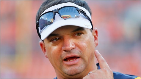 West Virginia coach Neal Brown made some bizarre comments to frustrated fans of the team. What did he say? Watch a video of his comments. (Credit: Getty Images)