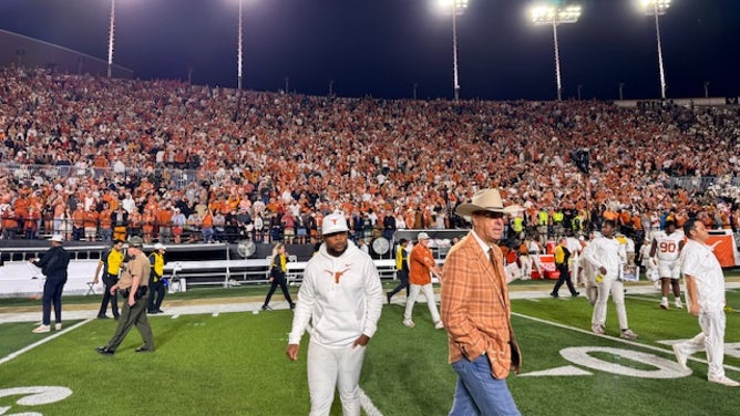 Texas AD Chris Del Conte leaves the field after victory over Vanderbilt