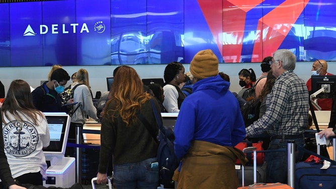 officer misses tackle of woman at delta check-in counter