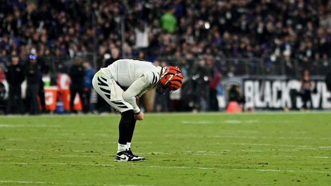 Cincinnati Bengals QB Joe Burrow bends over in pain vs. the Baltimore Ravens at M&T Bank Stadium. (Tommy Gilligan-Imagn Images)