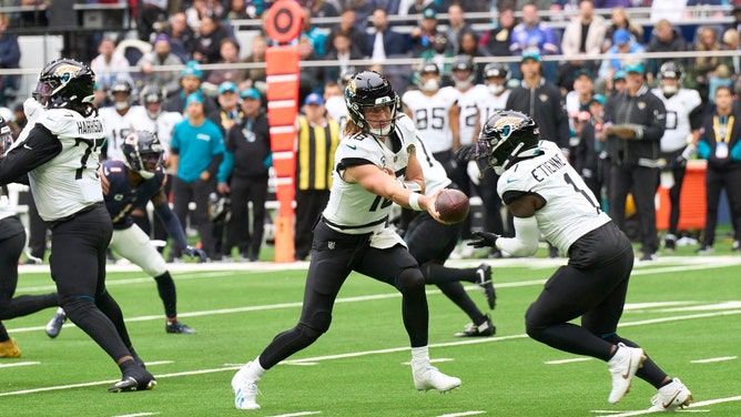 Jacksonville Jaguars QB Trevor Lawrence hands it off to RB Travis Etienne Jr. against the Chicago Bears in an NFL International Series game in London. (Photo credit: Peter van den Berg-Imagn Images)
