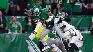 Philadelphia Eagles QB Jalen Hurts leaps for a touchdown vs. the Jacksonville Jaguars at Lincoln Financial Field in NFL Week 9. (Bill Streicher-Imagn Images)