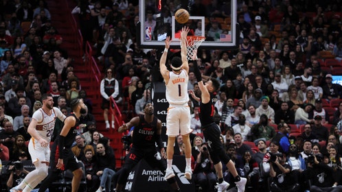 Phoenix Suns SG Devin Booker shoots a contested jumper over Heat SG Tyler Herro at Kaseya Center in Miami. (Sam Navarro-Imagn Images)