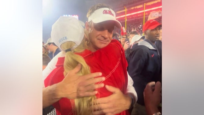 Lane Kiffin hugs his daughter Landry after the Ole Miss win over Georgia