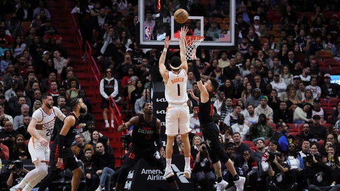 Phoenix Suns SG Devin Booker shoots a contested jumper over Heat SG Tyler Herro at Kaseya Center in Miami. (Sam Navarro-Imagn Images)
