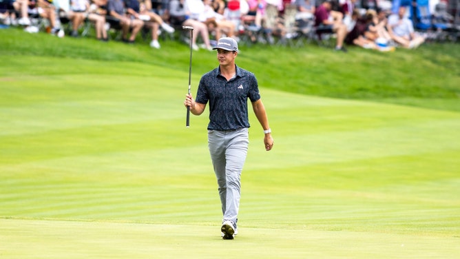 Michael Thorbjornsen raises his putter at the 18th green during the final round of the 2024 John Deere Classic. (Joseph Cress-Imagn Images)