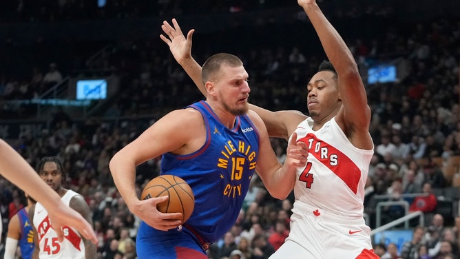 Denver Nuggets C Nikola Jokic pushes Toronto Raptors wing Scottie Barnes under the basket at Scotiabank Arena. (John E. Sokolowski-Imagn Images)
