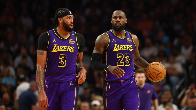 Los Angeles Lakers All-Stars LeBron James and Anthony Davis walking up the court against the Phoenix Suns at Footprint Center. (Mark J. Rebilas-Imagn Images)
