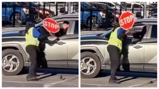 parking lot attendant hit driver with stop sign