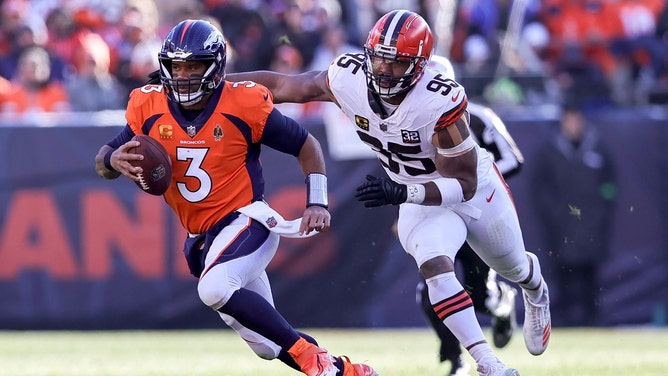 Former Denver Broncos QB Russell Wilson runs away from Cleveland Browns pass rusher Myles Garrett at Empower Field at Mile High in Colorado. (Steve Nurenberg/Icon Sportswire via Getty Images)
