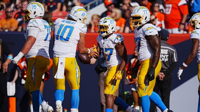 Los Angeles Chargers RB J.K. Dobbins celebrates his touchdown with QB Justin Herbert vs. the Denver Broncos in NFL Week 6 at Empower Field at Mile High. (Ron Chenoy-Imagn Images)