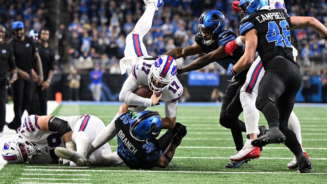 Buffalo Bills QB Josh Allen goes airborne for a first-down run vs. the Detroit Lions in NFL Week 15 at Ford Field. (Lon Horwedel-Imagn Images)
