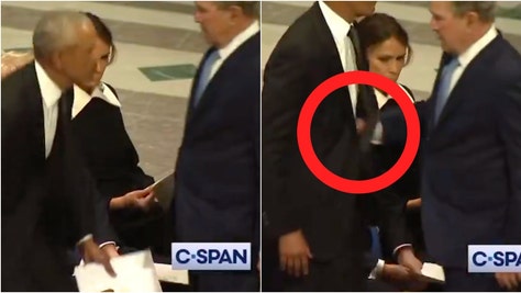 George W. Bush tapped Obama on the stomach at Jimmy Carter's funeral. (Credit: Screenshot/Twitter Video https://x.com/reesejgorman/status/1877386631482671579/CSPAN broadcast)