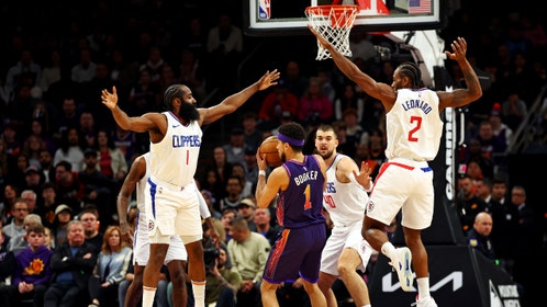 Los Angeles Clippers All-Stars James Harden and Kawhi Leonard pressure Phoenix Suns All-Star Devin Booker at Footprint Center. (Photo credit: Mark J. Rebilas-Imagn Images)